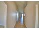 Long hallway featuring tile flooring and neutral walls leading toward a bright living space at 509 Heather Glen Dr, Winter Haven, FL 33884
