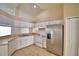 Bright kitchen with white cabinets and stainless steel appliances at 509 Heather Glen Dr, Winter Haven, FL 33884
