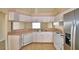 Kitchen featuring tile floor, white cabinets, and stainless steel appliances at 509 Heather Glen Dr, Winter Haven, FL 33884