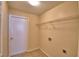 Functional laundry room featuring tile flooring and convenient shelving for storage at 509 Heather Glen Dr, Winter Haven, FL 33884