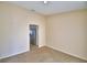 Open living room with neutral walls, plush carpeting, and doorway views into the kitchen, creating a cozy atmosphere at 509 Heather Glen Dr, Winter Haven, FL 33884