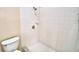 The bathroom features a tiled shower with white tiling, fixtures, and accents at 509 Heather Glen Dr, Winter Haven, FL 33884