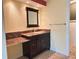 Bathroom vanity with dark cabinets, granite countertop and mirror at 579 Saint Andrews Rd, Winter Haven, FL 33884