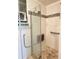 Bathroom shower featuring glass door, grab bar, shower seat and decorative tile at 579 Saint Andrews Rd, Winter Haven, FL 33884