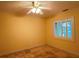 Bedroom with tile flooring, ceiling fan, and window with shutters at 579 Saint Andrews Rd, Winter Haven, FL 33884