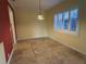 Dining room with yellow walls, white trim, tile floors, and a decorative light fixture at 579 Saint Andrews Rd, Winter Haven, FL 33884