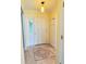 The entryway features yellow walls, a white door, a mosaic-patterned tile inset, and coat hooks at 579 Saint Andrews Rd, Winter Haven, FL 33884