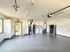 Spacious garage with ample storage, washer, dryer, and gray epoxy flooring at 579 Saint Andrews Rd, Winter Haven, FL 33884