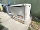 A GENERAC generator on a concrete slab, next to an A/C unit and a green exterior wall at 579 Saint Andrews Rd, Winter Haven, FL 33884