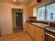 View of the kitchen with stainless appliances, stone countertops, and a double-basin sink at 579 Saint Andrews Rd, Winter Haven, FL 33884