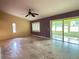Living room featuring tile floors, a ceiling fan, natural light, and access to the enclosed lanai at 579 Saint Andrews Rd, Winter Haven, FL 33884
