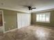 Spacious living room with tile flooring, ceiling fan, and window with shutters at 579 Saint Andrews Rd, Winter Haven, FL 33884