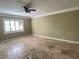 Spacious living room with tile flooring, ceiling fan, window with shutters and crown molding at 579 Saint Andrews Rd, Winter Haven, FL 33884