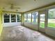 Bright sun room with tiled floor and multiple windows at 579 Saint Andrews Rd, Winter Haven, FL 33884