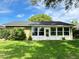 Bright sun room with large windows offering views of the lush green yard at 579 Saint Andrews Rd, Winter Haven, FL 33884