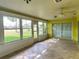 Bright sun room with tiled floor and multiple windows overlooking the yard at 579 Saint Andrews Rd, Winter Haven, FL 33884