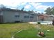 Green backyard featuring a pool, patio, and a designated area for outdoor relaxation at 614 Chatham Dr, Lakeland, FL 33803