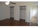 Bedroom featuring wood floors, a ceiling fan, and spacious closet space at 614 Chatham Dr, Lakeland, FL 33803