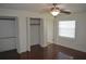 Bedroom with wood floors, a ceiling fan, a window, and spacious closet space at 614 Chatham Dr, Lakeland, FL 33803