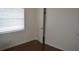 Bedroom with hardwood floors, a window with blinds, and a closet with a white door at 614 Chatham Dr, Lakeland, FL 33803