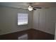 Spacious bedroom with wood flooring, window, ceiling fan, and closet at 614 Chatham Dr, Lakeland, FL 33803