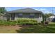 The front exterior of a single-story home with a green lawn and decorative foliage at 614 Chatham Dr, Lakeland, FL 33803