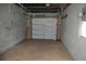 Spacious garage with concrete floor and a white garage door at 614 Chatham Dr, Lakeland, FL 33803