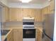 Efficient kitchen featuring wood cabinets, ample counter space, and stainless steel refrigerator at 614 Chatham Dr, Lakeland, FL 33803
