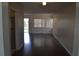 Open-concept living room with wood floors and large windows providing abundant natural light at 614 Chatham Dr, Lakeland, FL 33803