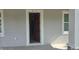 Front door leads into the home, framed by white trim and flanked by windows for natural light at 615 Avenue S Ne, Winter Haven, FL 33881