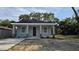 Charming single-story home featuring neutral paint, black shingle roof and decorative stone accents at 615 Avenue S Ne, Winter Haven, FL 33881