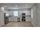 Kitchen with stainless steel appliances, white cabinets, and a window for ample light at 615 Avenue S Ne, Winter Haven, FL 33881