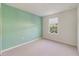 Simple bedroom with a large window, soft carpet, and minimalist decor at 6237 Aralia Ivy Ln, Winter Garden, FL 34787
