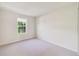 This bedroom has neutral carpet, a window with blinds, and white walls at 6237 Aralia Ivy Ln, Winter Garden, FL 34787
