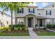 Charming two-story home with inviting front porch, blue shutters, and well-manicured landscaping at 6237 Aralia Ivy Ln, Winter Garden, FL 34787