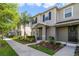Charming two-story townhome features neat landscaping and a welcoming front porch at 6237 Aralia Ivy Ln, Winter Garden, FL 34787