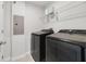 This laundry room features newer front load washer and dryer, and wire shelving at 6237 Aralia Ivy Ln, Winter Garden, FL 34787