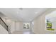 Bright living space boasts tile flooring, neutral walls, and ample natural light with staircase to the second level at 6237 Aralia Ivy Ln, Winter Garden, FL 34787
