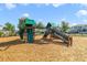 Community playground with climbing wall, slides, and wood chip ground covering at 6237 Aralia Ivy Ln, Winter Garden, FL 34787