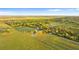 Picturesque aerial view of a property featuring green pastures, trees, a location marker and a charming home site at 6430 Russo Rd, Bartow, FL 33830