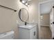 Bathroom with updated vanity, granite countertop, updated fixtures, and round mirror at 6430 Russo Rd, Bartow, FL 33830
