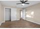 Bedroom featuring wood-look floors, large closet, and neutral paint tones at 6430 Russo Rd, Bartow, FL 33830