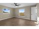 Bright bedroom features wood-look floors, neutral walls, ceiling fan, and lots of natural light at 6430 Russo Rd, Bartow, FL 33830