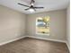 Bedroom featuring a ceiling fan, wood-look floors, and a sunny window at 6430 Russo Rd, Bartow, FL 33830