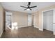 Spacious bedroom features a ceiling fan, wood-look floors, ensuite bathroom, and a closet at 6430 Russo Rd, Bartow, FL 33830