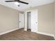 Bedroom featuring wood-look floors, ceiling fan, closet, and neutral colored walls at 6430 Russo Rd, Bartow, FL 33830