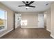 Bedroom featuring a ceiling fan, wood-look floors, ensuite bathroom, and a closet at 6430 Russo Rd, Bartow, FL 33830