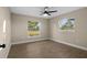 Bright bedroom with wood-look floors, ceiling fan, and natural light from two windows at 6430 Russo Rd, Bartow, FL 33830