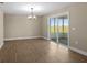 Dining area features wood floors, a chandelier, and sliding glass doors to the patio at 6430 Russo Rd, Bartow, FL 33830