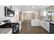 Open-concept kitchen featuring modern stainless steel appliances and wood floors at 6430 Russo Rd, Bartow, FL 33830